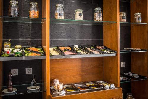 a pantry with shelves filled with different types of food at Residencial Mar e Sol in Costa da Caparica