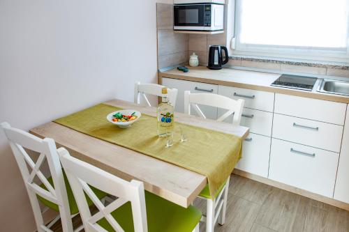a kitchen with a wooden table with a bowl of food on it at Rooms Šajina in Podgrad
