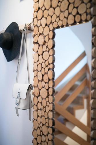 a stack of wood next to a mirror at Chalet Ana Bohinj in Bohinj