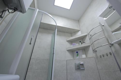 a bathroom with a shower with a glass door at Уютная Студия на Парковой 29 in Sevastopol