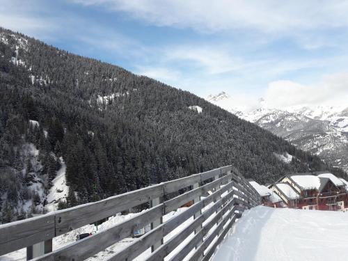 a view of a snow covered mountain with a ski lodge at Le Thabor in Valfréjus