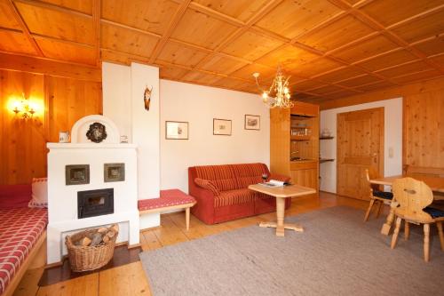 a living room with a couch and a fireplace at Appartements Kirchenwirt in Kirchberg in Tirol
