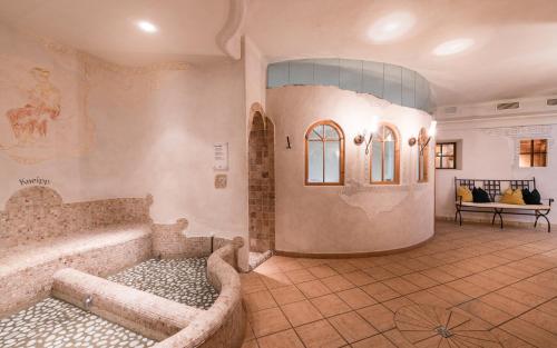 a large bathroom with a tub in a room at Sporthotel Exclusive in San Vigilio Di Marebbe