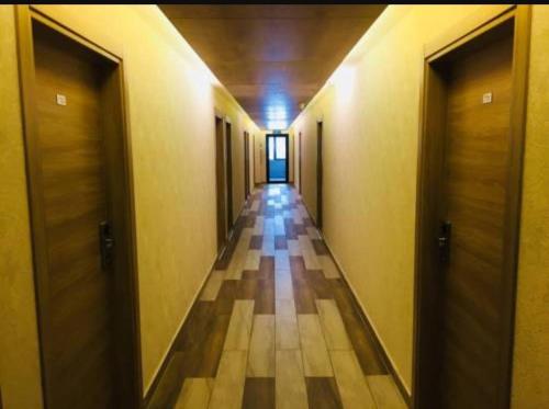 an empty hallway with two doors and a tile floor at ORBI PALACE DELUX Bakuriani room 470 in Bakuriani