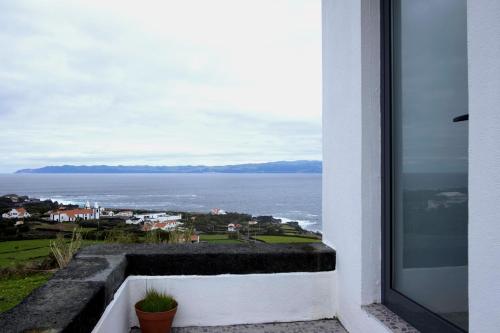 a balcony with a view of the ocean at Susete Village in São Roque do Pico
