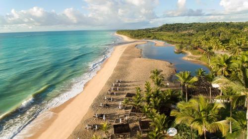 an aerial view of a beach with palm trees and the ocean at Rio Da Barra Villa Hotel in Trancoso