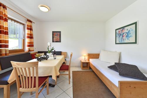 a room with a table and a bed and a dining room at Fuchshof in Perca