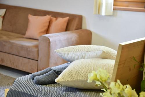 a living room with a couch and a chair and pillows at Fuchshof in Perca