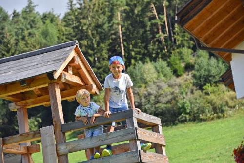a man and a child standing in a play structure at Fuchshof in Perca