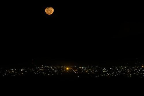 a full moon over a city at night at Nabana Lodge in Hazyview