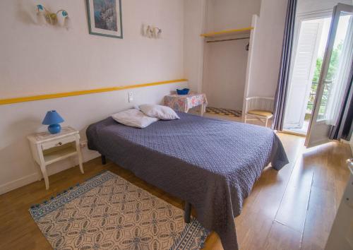 a bedroom with a bed with a blue blanket at Andrea Fera in Brive-la-Gaillarde