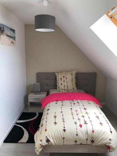 a bedroom with a bed in a attic at Les Charmantes in Cernay