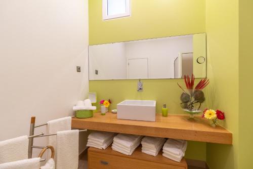 a bathroom with a sink and a mirror at Zeza´s house in Calheta