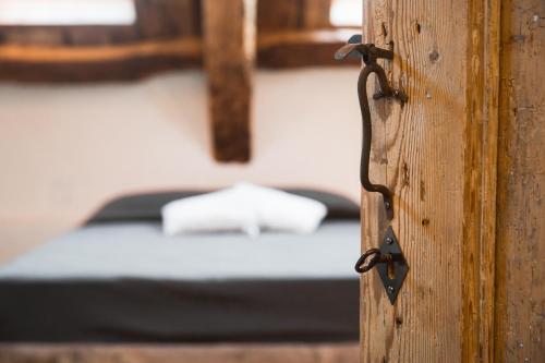 a close up of a wooden door with a bed at Relais Poggio Pagnan in Farra