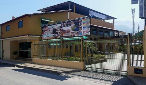 a building with a fence in front of it at Pousada H&D in Angra dos Reis