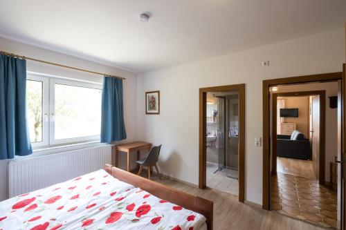 a bedroom with a bed and a window at Gailtal Panorama in Kötschach