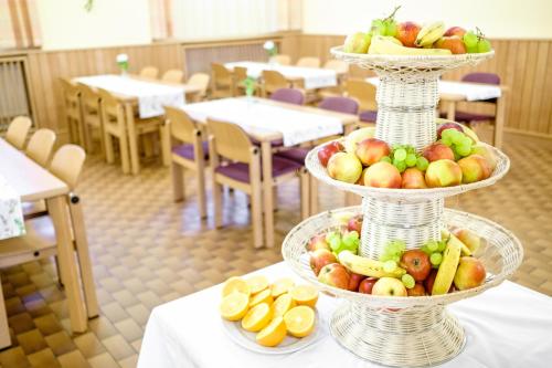 two tiers of fruit on a table in a restaurant at Sommerhotel Don Bosco in Vienna