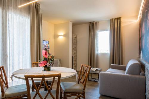 a living room with a table and a couch at Hotel Ambassador in Bibione