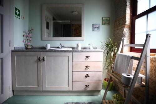 a bathroom with a sink and a mirror at Casa do Lonho in Arouca
