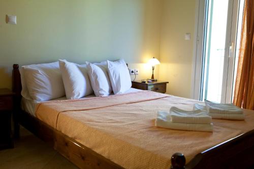 a bedroom with a bed with two towels on it at Evangelia in Ayia Evfimia