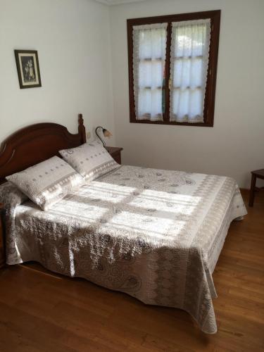 a bedroom with a bed with a blanket on it at Bizentenea in Zugarramurdi