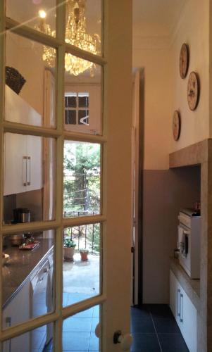a kitchen with a door leading into a kitchen with a window at Whatever Art B&B in Lisbon