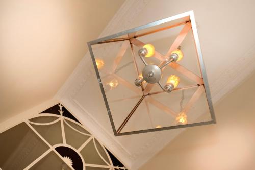 a glass chandelier hanging from a ceiling at Edgar Townhouse in Bath