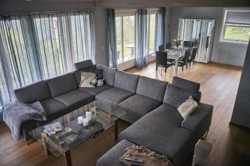 a living room with a couch and a dining room at Panorama view along the fjord in Stryn in Blakset