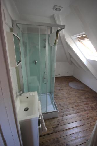 La salle de bains mansardée est pourvue d'une douche et d'un lavabo. dans l'établissement La Maison de Beauport, à Paimpol