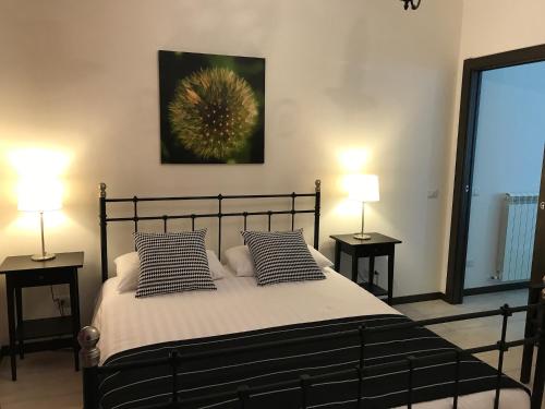 a bedroom with a bed with pillows and two lamps at Casa Elena in Camporgiano