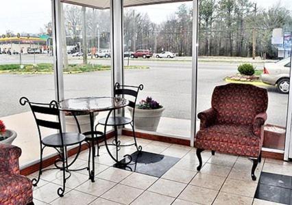 a room with a table and a chair and a window at Americas Best Value Inn Richmond VA Midlothian Turnpike in Richmond