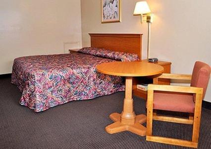 a hotel room with a bed and a table and chair at Americas Best Value Inn Richmond VA Midlothian Turnpike in Richmond