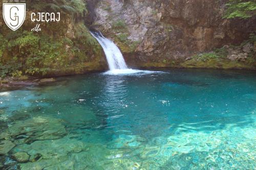 a painting of a waterfall in a pool of water at Villa Gjeçaj Guesthouse and Restaurant in Theth