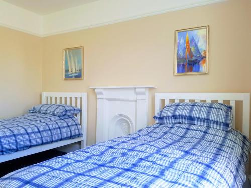 a bedroom with two beds and a fire place at Big, Beautiful, Cosy Falmouth House in Falmouth