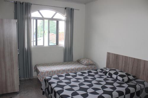 A bed or beds in a room at Pousada Bela Vista