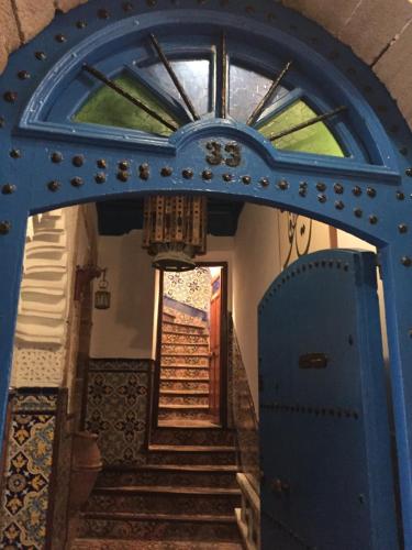an entrance to a house with a blue door at Dar Halima in Essaouira