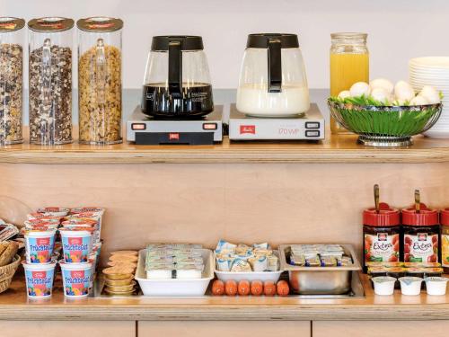 a shelf with food and appliances on it at ibis budget Nürnberg City Messe in Nürnberg