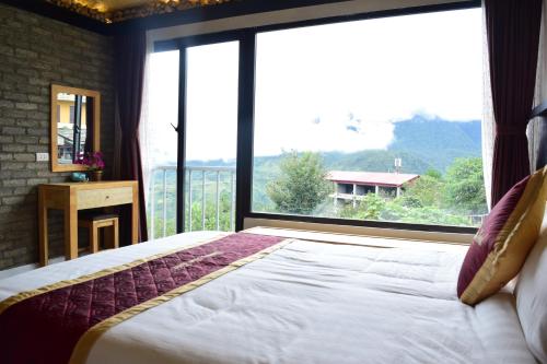 a bedroom with a bed and a large window at Phuong Nam Hotel in Sa Pa