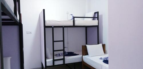 a room with three bunk beds in a room at I & I Hostel in Mirissa