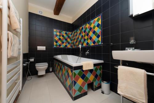 a bathroom with a tub and a sink and a toilet at Hotel Barcadam in Banská Štiavnica