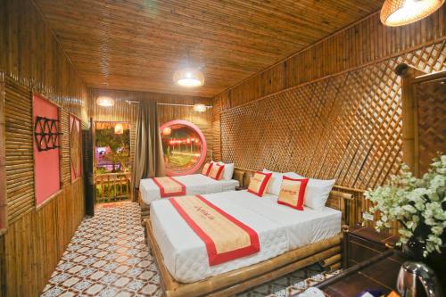 Giường trong phòng chung tại Trang An Bungalow
