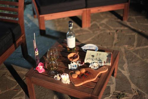 a table with a bottle of wine and glasses on it at Tenuta Terre di Bosco Oasi di Relax nel Cilento in San Giovanni a Piro