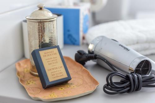 a table with a blow dryer and a book on it at Formosa Guest House in Tavira