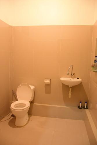a bathroom with a toilet and a sink at Sunari Beach Resort 2 in Selayar