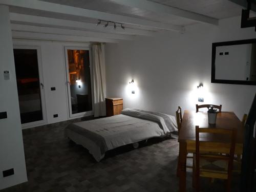 a bedroom with a bed and two tables and a tv at Via Pezza 100 in Ragusa