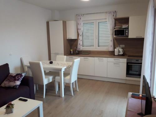 a kitchen and a table and chairs in a room at Villa Natasha in Makarska