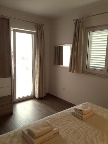a bedroom with a bed with two towels on it at Villa Natasha in Makarska