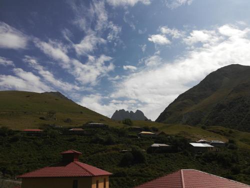 a view of a valley with buildings and mountains at Levan & Megi in Jut'a