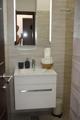 a bathroom with a white sink and a mirror at AURA Residence in Rovinj