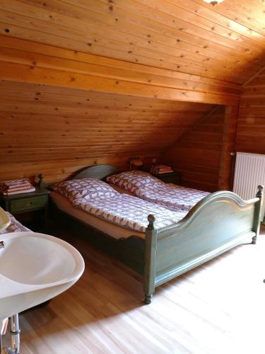 a bedroom with a bed in a wooden cabin at Holzhaus am Silbersee in Frielendorf